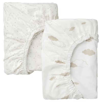 Two white baby fitted sheets, one with beige dots, the other with beige clouds, folded.