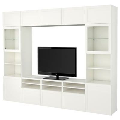 Ikea BESTÅ white tv unit with adjustable shelves, cupboards, and glass doors for storage and media display.