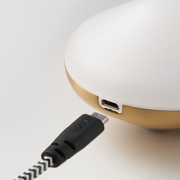 A close-up of a small, elegant led light with a usb port on its underside, designed for easy charging.