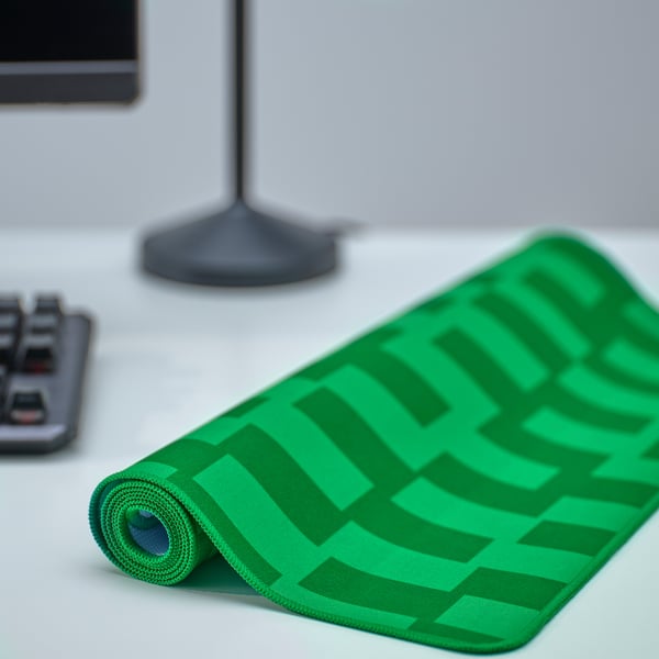 Green chequered gaming mouse pad on desk, ideal for gaming.
