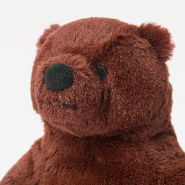 Cuddly teddy bear with soft, plush brown fur, small black eyes, and a friendly face.