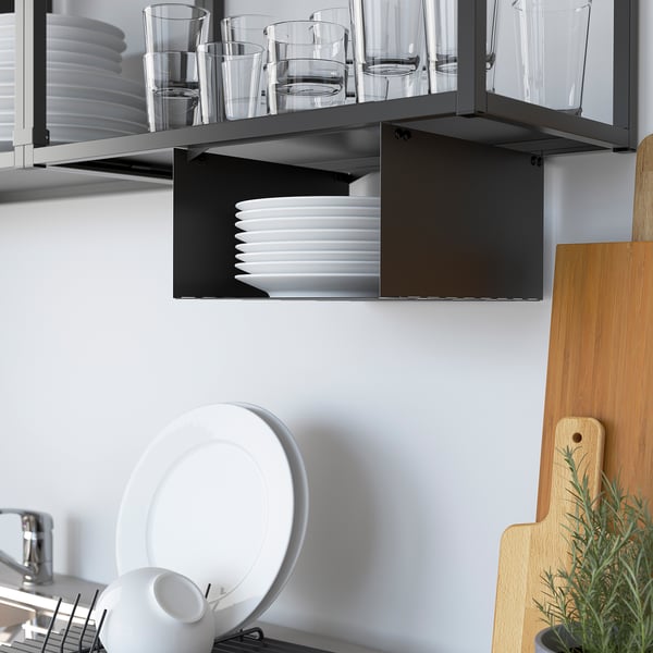 Kitchen storage unit with open shelves displaying cups, glasses, and plates. Steel frame fits neatly under cabinets.