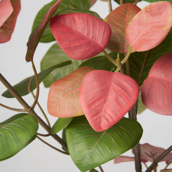 Vibrant artificial plant with deep green and bright pink leaves, arranged on a stem, showcasing lifelike quality and vivid colour.