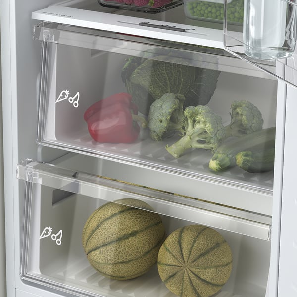 Fridge with adjustable glass shelves, led lighting, and humidity-controlled crisper fully stocked with vegetables and melons.