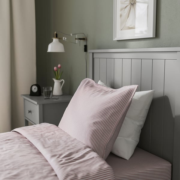 GULLABERG bed with striped linens, white pillow, grey bedside table.