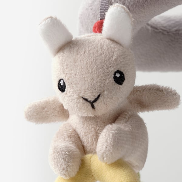 Stuffed animal toy with soft beige fur, black eyes, small smile, white ears, and yellow feet. Ideal for babies.