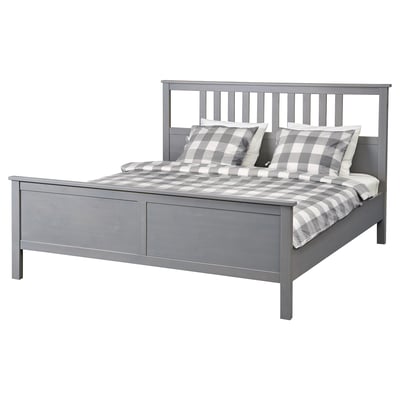 Modern grey wooden bed with chequered bedding.