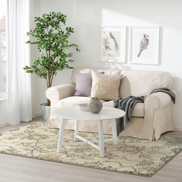 HOLSTEBRO beige floral rug: rectangular, fits under light couch, intricate patterns, stain-resistant, polypropylene.