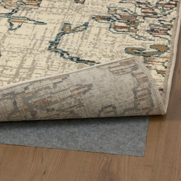 Stylish rug with intricate patterns on wooden floor.
