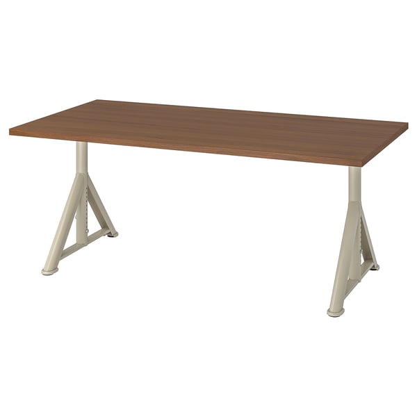 An IDÅSEN desk with a brown top and cream legs, rectangular shape, and metal frame.