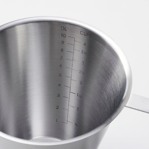 Stainless steel measuring cup with clear cup and ounce markings. Simple and precise.