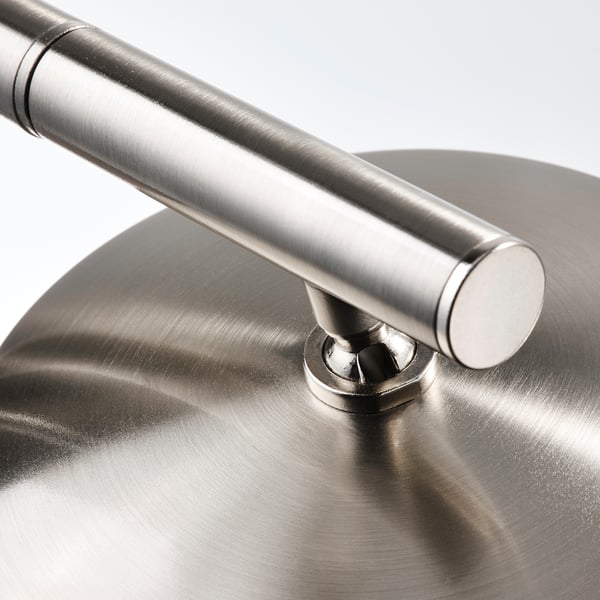 Close-up of modern lamp base, sleek nickel-plated steel, sturdy design.