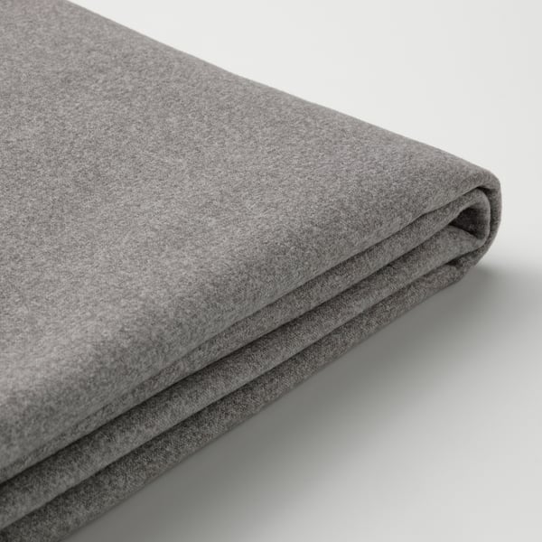 Close-up of soft, textured grey upholstery on modern, modular sofa piece.