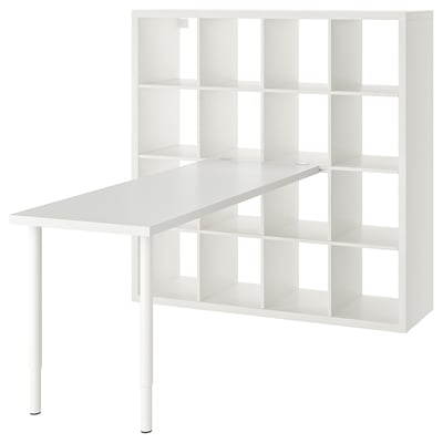Depicts an ikea KALLAX unit in white, combining a desk and shelving for storage.