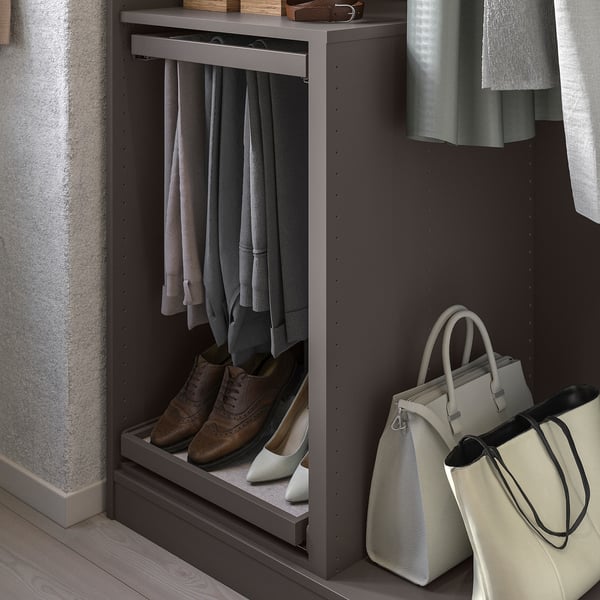 A KOMPLEMENT wardrobe organiser with grey shelves storing various clothing items and accessories.