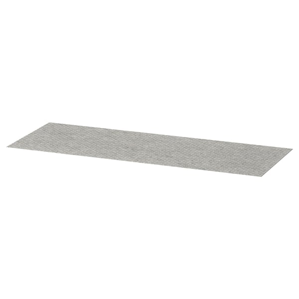 A grey KOMPLEMENT drawer mat, rectangular, made of polyester with a dotted surface design.
