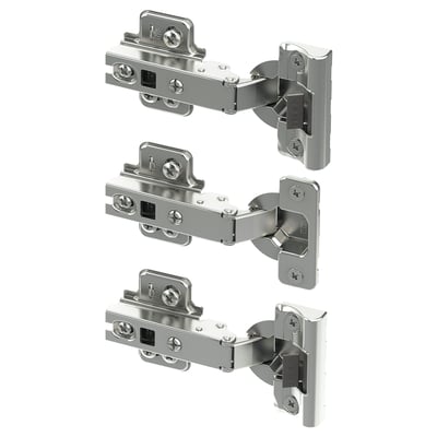 Three silver metal hinges with screws, designed for cabinet doors, shown in an organised manner.