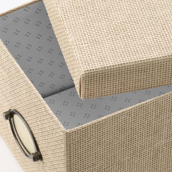 Woven paper storage box with metal handle, open lid revealing patterned interior.