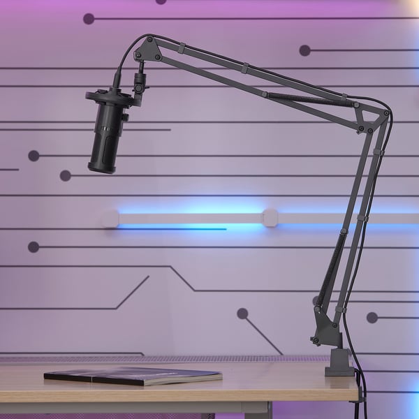Black mic arm clamped on desk, adjustable 360° for recording.
