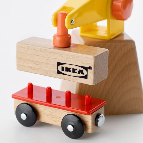 Wooden toy crane with bright red wagon, labelled IKEA.