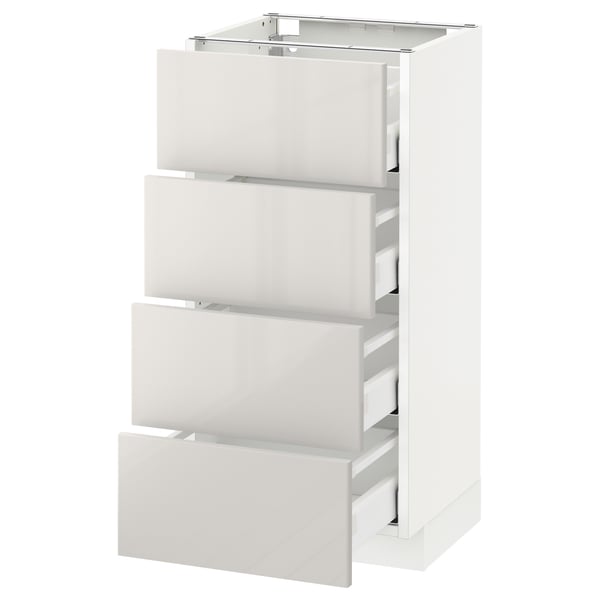 A white, modern kitchen cabinet drawer unit from the METOD system. It four smooth, self-closing drawers with a high-gloss finish.