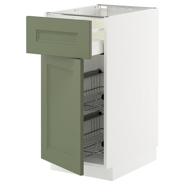An open, green and white kitchen cabinet with a wire basket.