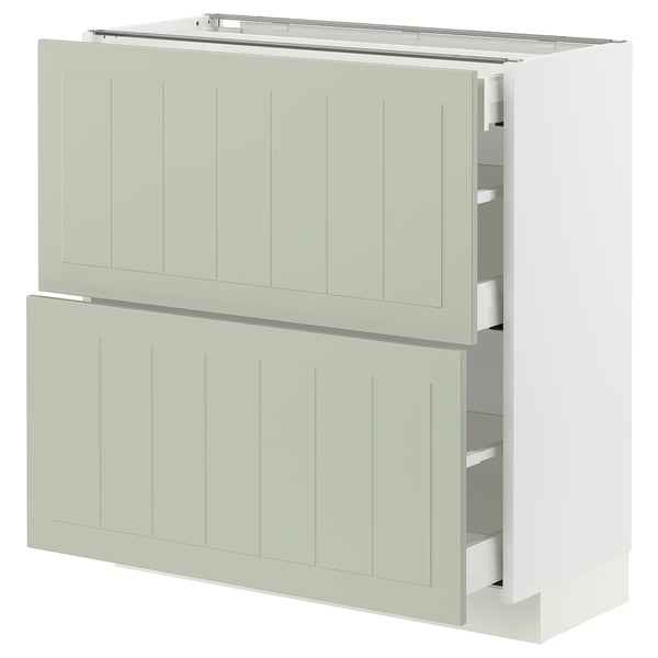 Modern kitchen unit in light green with two drawers and two cabinet doors, sleek and minimalist design.