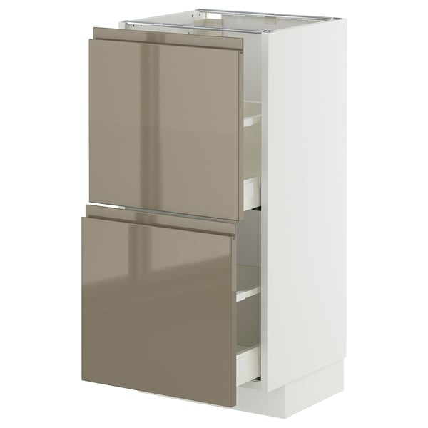 A white METOD kitchen cabinet with dark grey-brown high gloss doors and integrated handles.