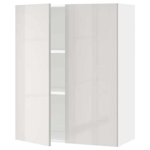 A white METOD kitchen cabinet with a modern design, featuring a sleek high gloss finish and adjustable shelves.