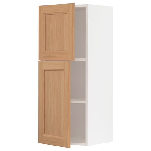 White tall kitchen cabinet with two oak doors and shelves.