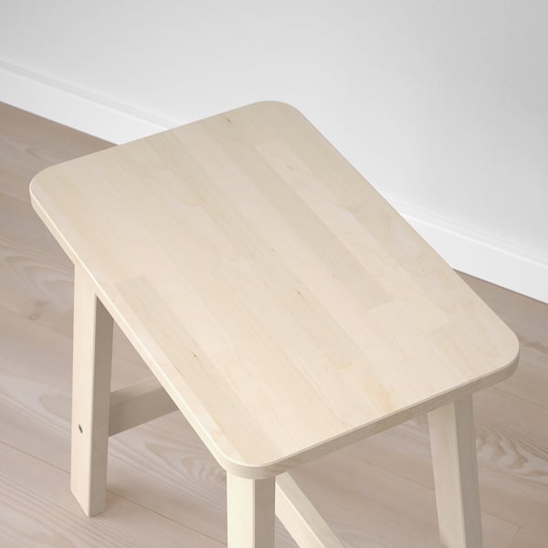 Minimalist, sturdy wooden stool in natural birch. Strong and simple, for public use.