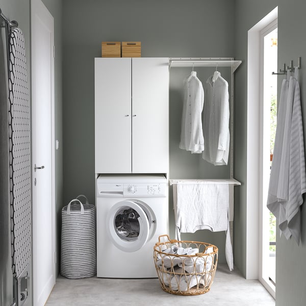 Modern laundry room with NYSJÖN cabinet, clothes rack, and organiser.