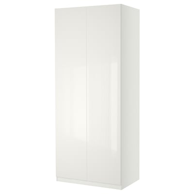 A white PAX wardrobe with a sleek, rectangular design. It stands tall with smooth, glossy surfaces.