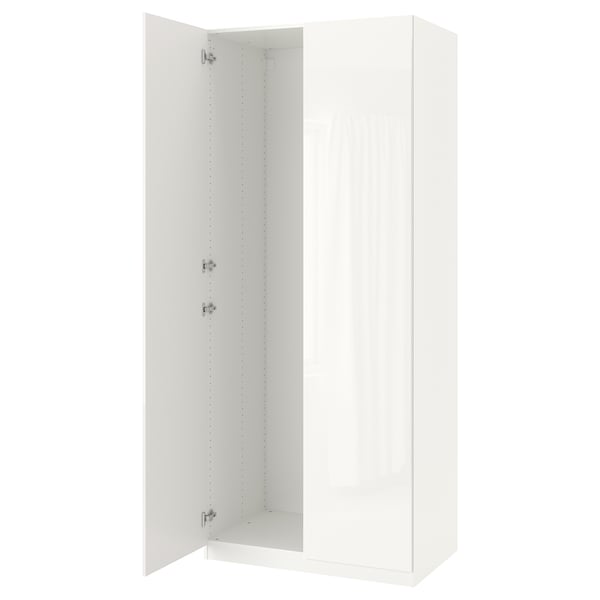 A white PAX wardrobe with one door open, revealing internal shelving. It adjustable feet and soft closing hinges.