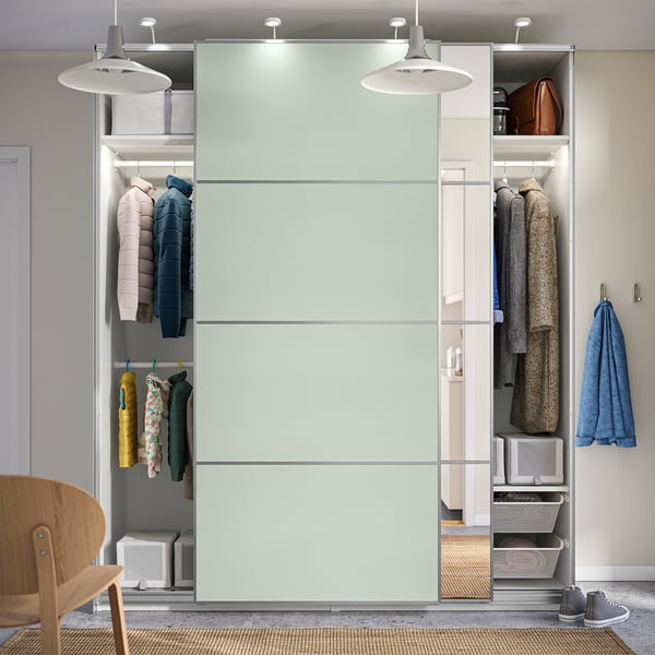 Modern wardrobe with sliding doors, hanging clothes, shelves, and overhead storage. Soft-close mechanism and adjustable feet for floor irregularities.
