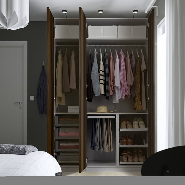 Open wardrobe displays clothes, shoes, and accessories on hangers, shelves, and drawers.