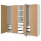 Modern light wood PAX wardrobe shows open drawers and shelves, showcasing organised storage. White and wooden tones.