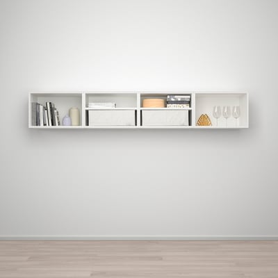 White wall-mounted shelf with compartments holding books, vases, boxes, and wine glasses.