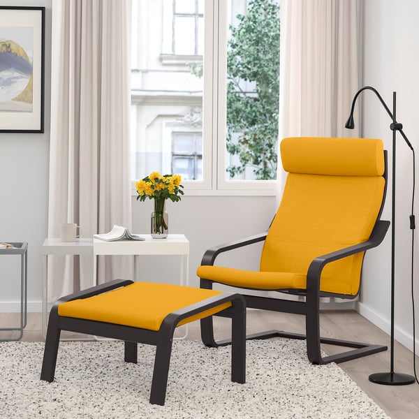 Yellow POÄNG chair & ottoman, wood frames, cushioned, by window. Minimalist.