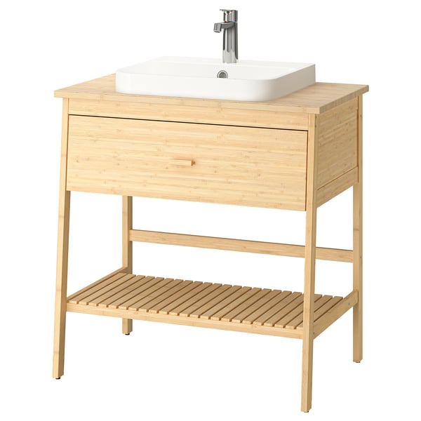 Wooden bathroom vanity with single drawer and open shelf, featuring a square white basin, sleek design, four thin legs, and chrome tap.