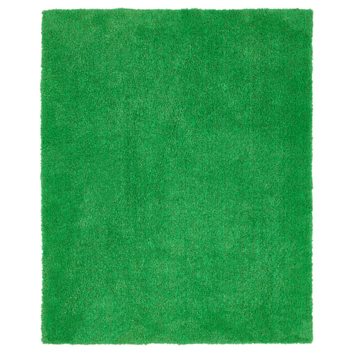 Bright green, rectangular, plush indoor/outdoor rug with a textured, grass-like surface.