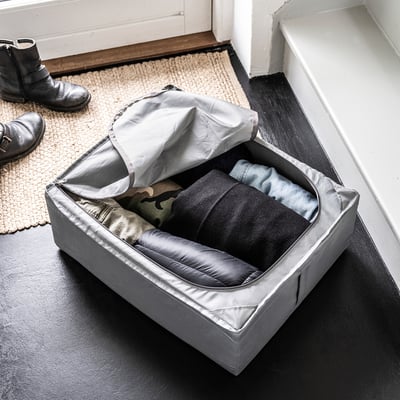 SKUBB storage case, grey, fabric with ventilation, rectangular, open with clothes inside.