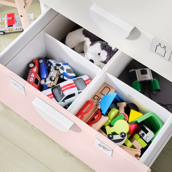 Organised toy storage: white SMÅSTAD drawers filled with colourful toys.