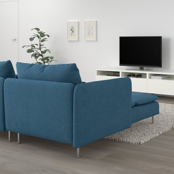 Modern living room with blue SÖDERHAMN sofa, tv, plant. Clean lines, minimalist design.