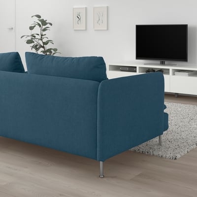 Blue SÖDERHAMN sofa in minimalist living room, deep & comfy, chenille fabric, high legs. Tv, plant, matching rug.
