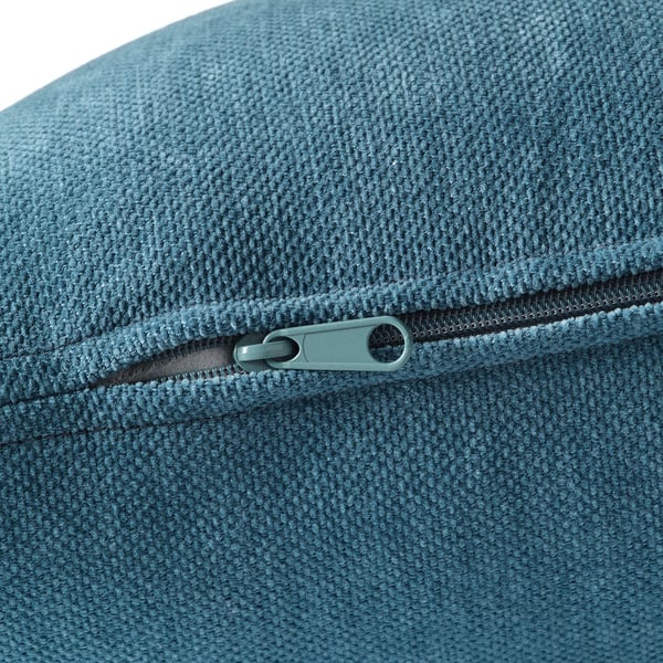 Close-up of a zip on a well-crafted, teal-colored upholstery, highlighting its quality and texture.
