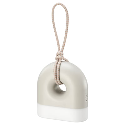 A SOLVINDEN lamp, white and grey, shaped like a donut with a handle. Its designed for both indoor and outdoor use.