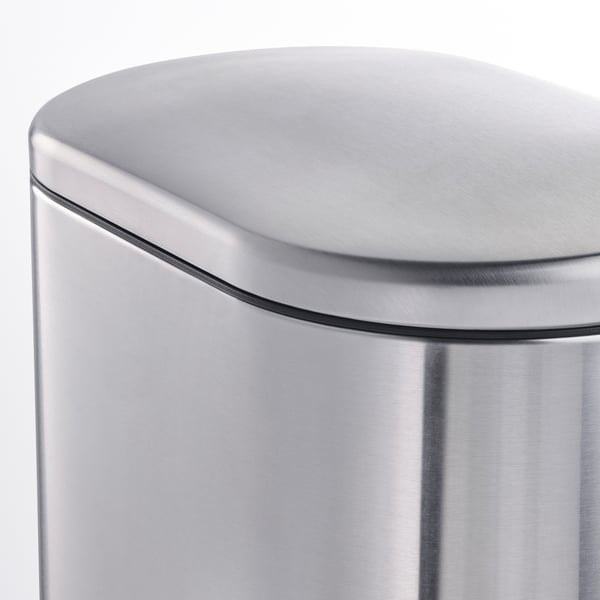 Close-up of a sleek, stainless steel rubbish cans curved, smooth lid edge, showcasing its modern, sturdy design.