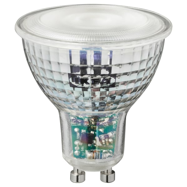 An ikea TRÅDFRI smart led bulb, spherical top, clear, dimmable, with internal blue and green pcb components, made of polycarbonate plastic.