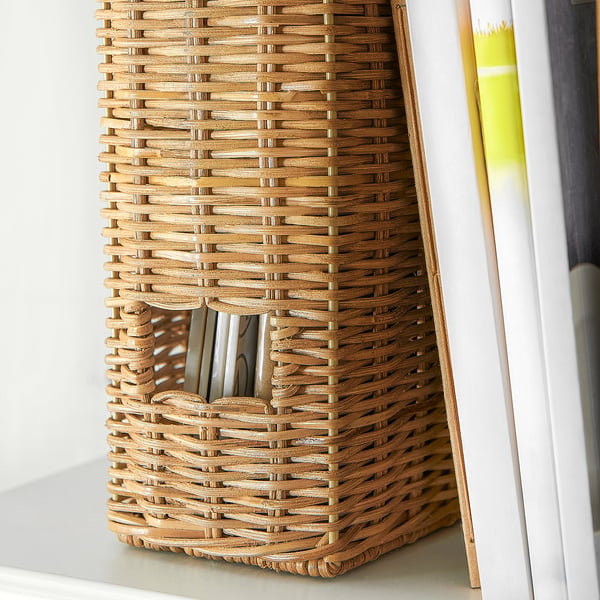 Woven rattan storage basket holds papers neatly, beige colour.